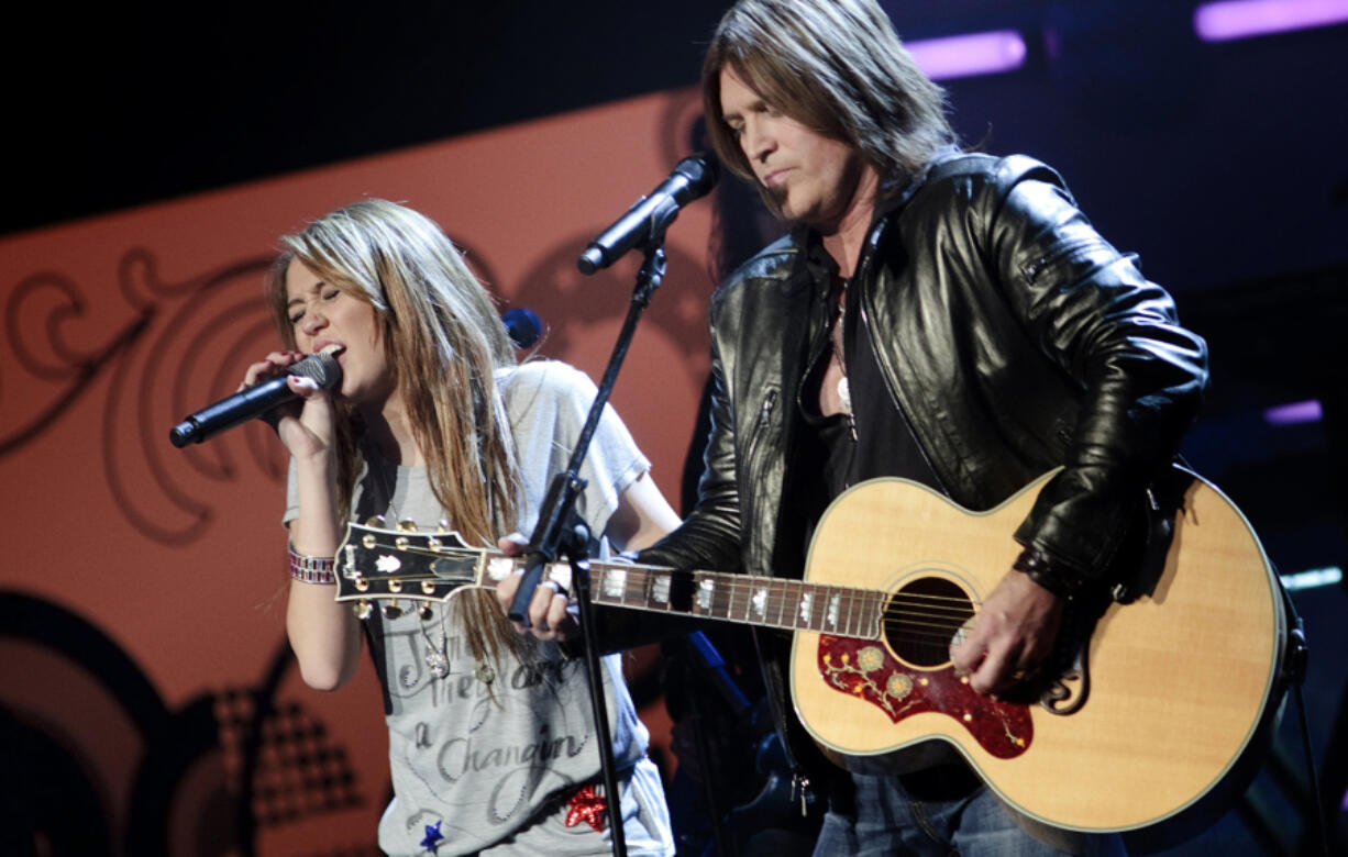 Miley Cyrus performs with her father Billy Ray Cyrus during the We Are The Future kids Ball Jan. 19, 2009, in Washington, DC.  President Elect Barack Obama will be sworn in as the 44th President of the United States tomorrow.
