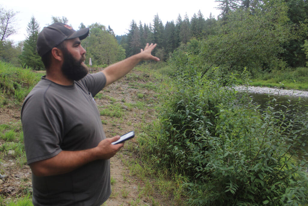 Washougal resident Mike Duzan on Monday, Sept. 4, 2023, gestures to a portion of a 150-acre property near his home that is slated for development as an adventure park.