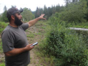 Washougal resident Mike Duzan on Monday, Sept. 4, 2023, gestures to a portion of a 150-acre property near his home that is slated for development as an adventure park.