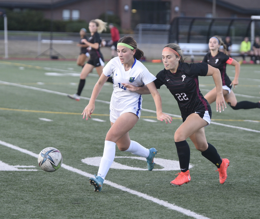 Mountain View's Courtney Shum, left, and Prairie's Avery Hoskins battle for the ball in a 3A Greater St. Helens League soccer match on Monday, Sept, 11, 2023 at Prairie High School.