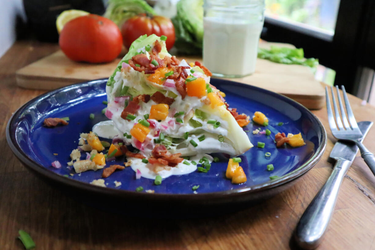 A towering iceberg wedge salad topped with crumbled bacon and blue cheese dressing is a classic steakhouse side.