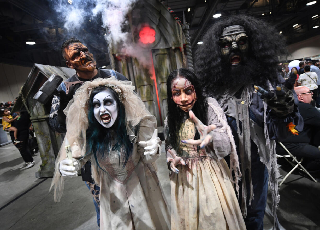 Actors from Knott's Scary Farm pose July 29, 2018, at the annual "Midsummer Scream Horror Convention" in Long Beach, Calif. The theme park's annual event marks 50 years this fall.
