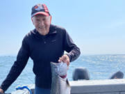 Richard Borneman of Vancouver is all smiles after landing this fall chinook recently at Buoy 10.