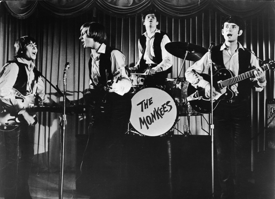 Television still shows the popular music and television group the Monkees as they perform onstage in an episode of their self-titled TV show, in the late 1960s. From left, Davy Jones, Peter Tork, Micky Dolenz (on drums) and Mike Nesmith.