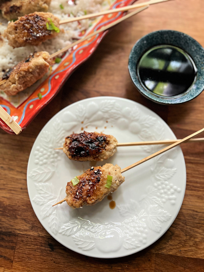 Chicken skewers with a salty-sweet yakitori sauce are simmered in water before being glazed on the grill.