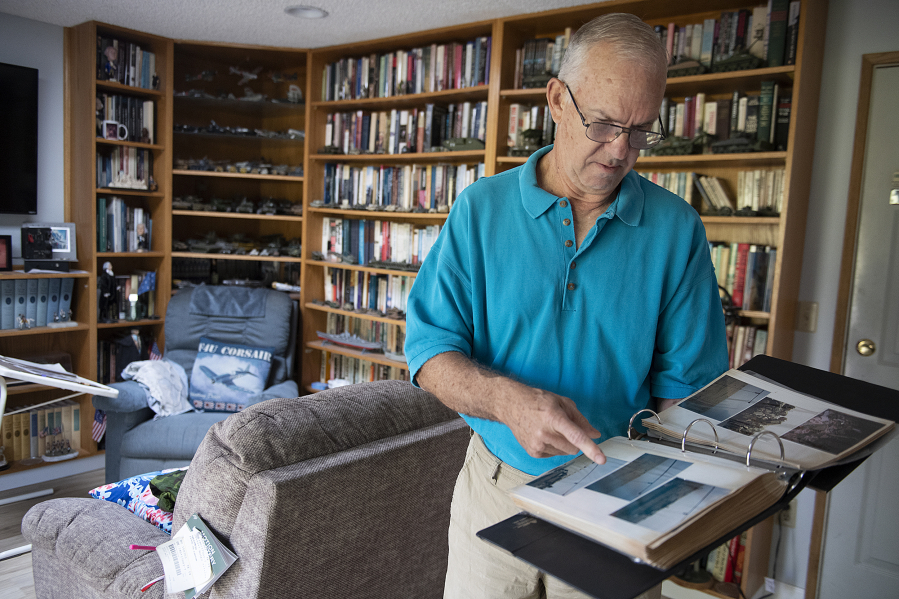 Author and former U.S. Marine Jeff Dacus looks over an album of photos from his service in the Persian Gulf War in 1991.