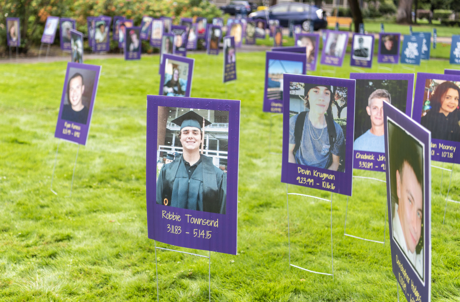 Photos of overdose victims fill a field during an Overdose Awareness Day event.