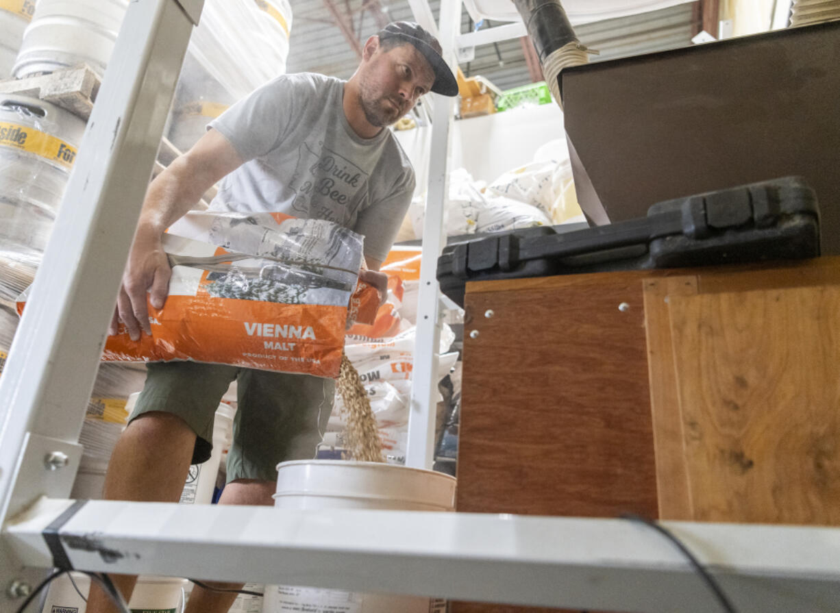 Fortside Brewing head brewer Paul Thurston measures out a bag of Vienna malt on Thursday at Fortside Brewing in central Vancouver. Fortside Brewing was a plaintiff in a 2022 lawsuit over Oregon's restrictions on Washington brewers selling their products in Oregon.