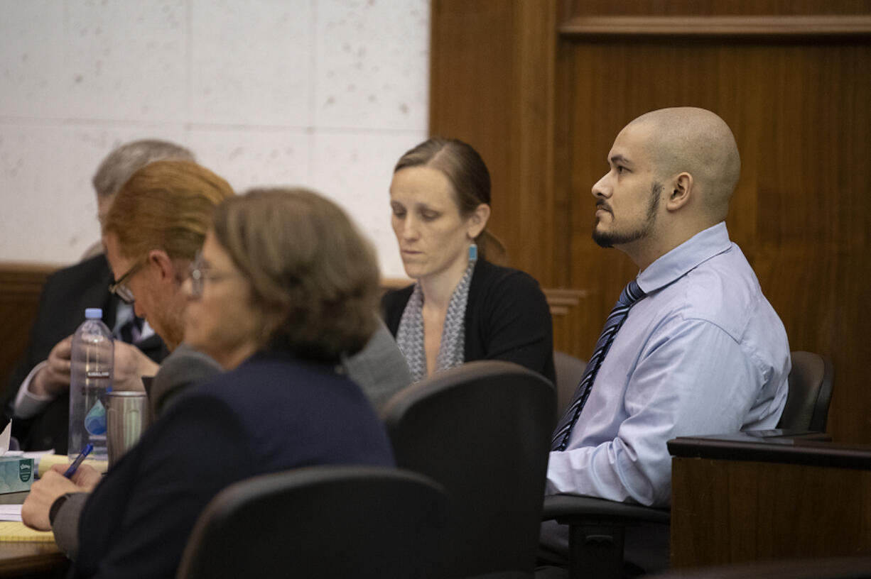 Defendant Guillermo Raya Leon, right, with his defense team Sept. 8 at the Clark County Courthouse before opening statements in his aggravated murder trial.