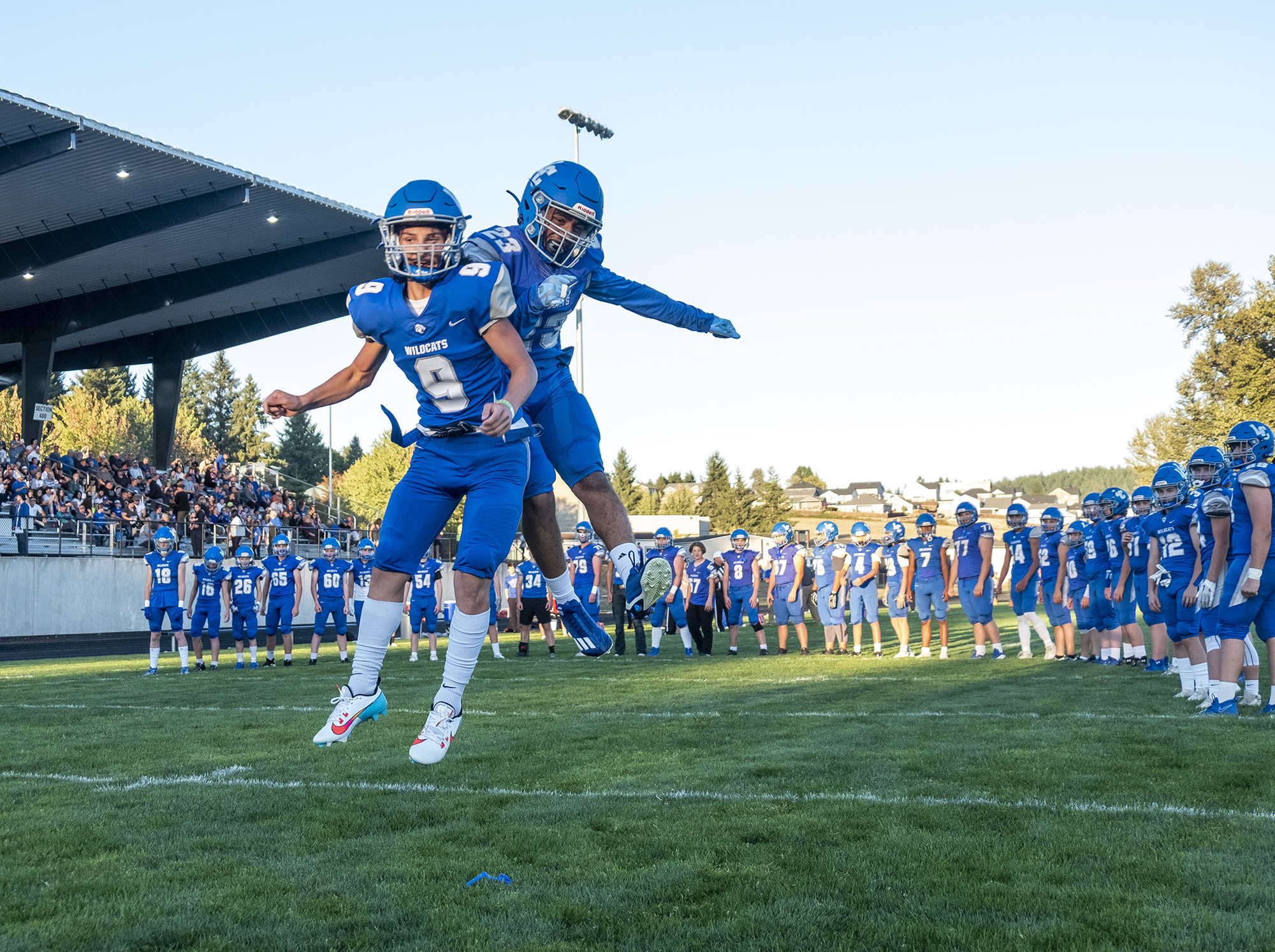 La Center sophomore Johnny Linstroth, left, and senior Jalen Ward meet in the air during pregame introductions Friday, Sept. 8, 2023, before a game against Woodland at La Center High School.
