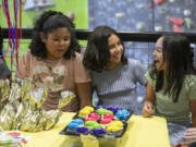 Mia Roman, left, Lucia Aberin and Kalea Maluneda-Telles, laugh before eating cupcakes at Lucia's 10th birthday party on Sunday at The Source Climbing Center. Gyms, bowling alleys and indoor playgrounds are among the many options in greater Vancouver for parents looking to host a birthday parties for their children.