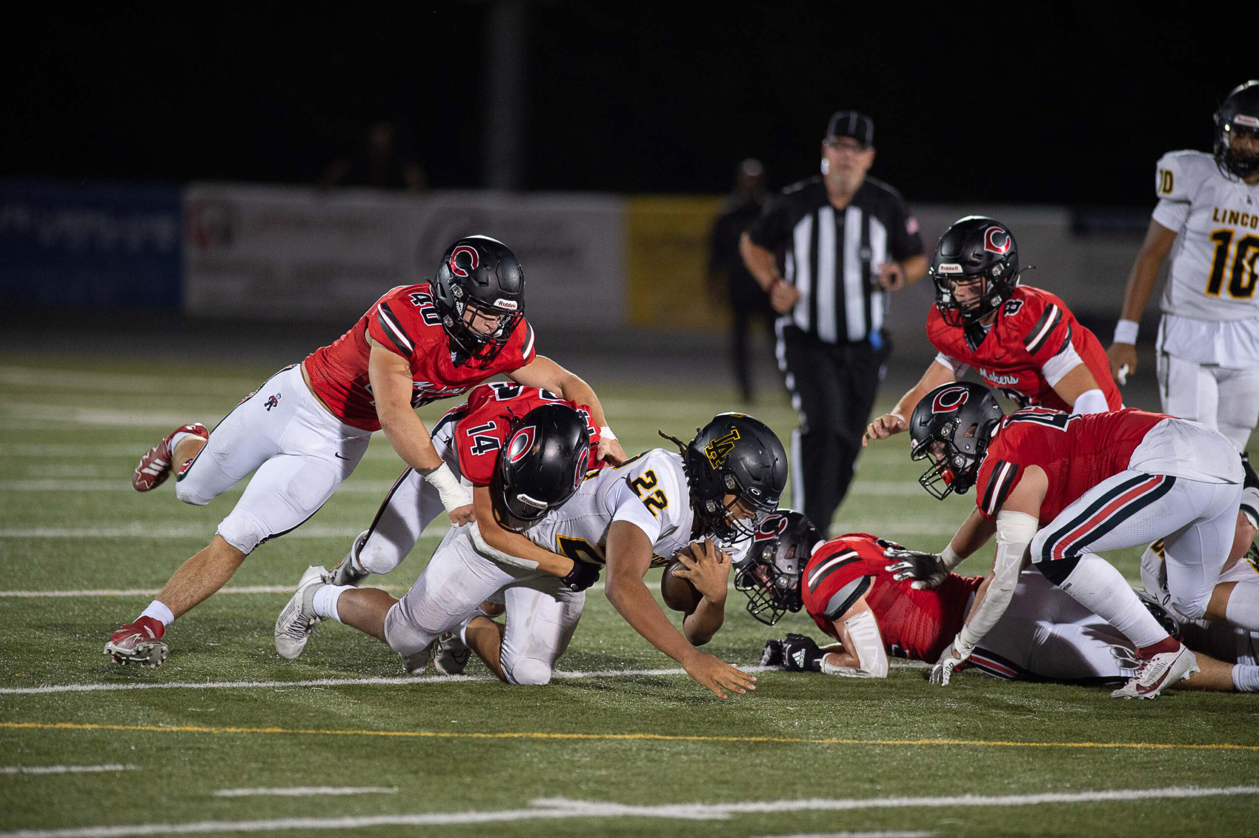 Lincoln's Jadeon Scranton (22) is tackled by Beau Harlan of Camas during the Papermakers' non-league football game against the Abes on Friday, Sept. 15, 2023, at Doc Harris Stadium.