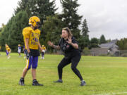 Columbia River assistant defensive coach Ruth Ingebrand, right, coaches a player Tuesday, Sept. 26, 2023, during football practice at Columbia River High School.