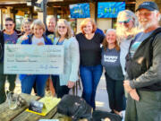 The dragon boat charity organization Paddle For Life recently presented the Catch-22 Breast Cancer Survivors Dragon Boat Team with a $8,000 check from a fundraiser held in Ridgefield last month.