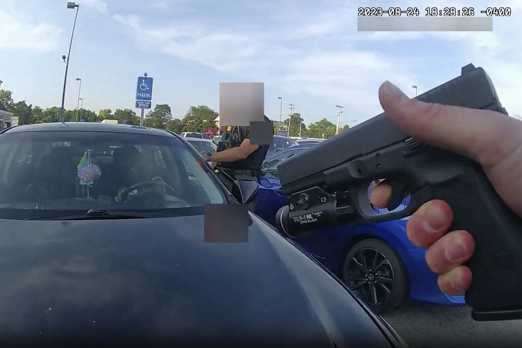 This still image from bodycam video released by the Blendon Township Police on Friday, Sept. 1, 2023, shows an officer pointing his gun at Ta’Kiya Young moments before shooting her through the windshield outside a grocery store in Blendon Township, Ohio, a suburb of Columbus, on Aug. 24. The pregnant Black mother was pronounced dead shortly after the shooting. Her unborn daughter did not survive. The video was pixelated by the source.