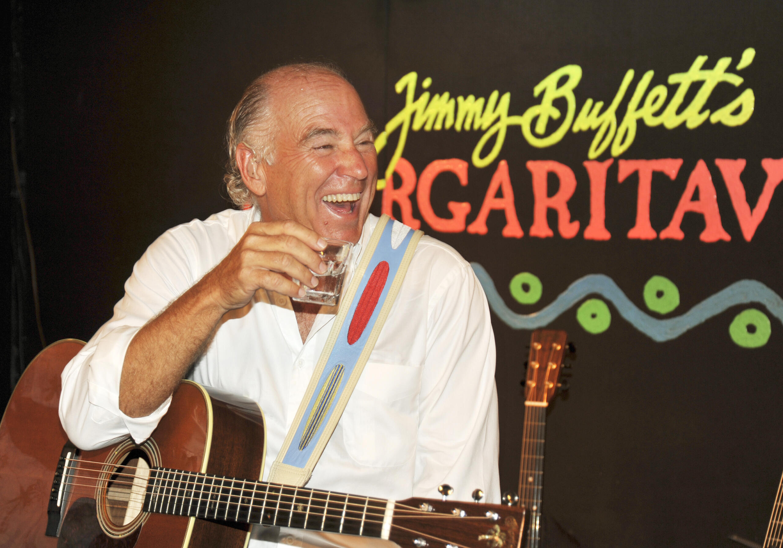 FILE - Jimmy Buffett takes a break during a set of music at his Margaritaville Cafe in Key West, Fla in Feb. 12, 2009. Buffett, who popularized beach bum soft rock with the escapist Caribbean-flavored song “Margaritaville” and turned that celebration of loafing into an empire of restaurants, resorts and frozen concoctions, has died, Friday, Sept. 1, 2023.