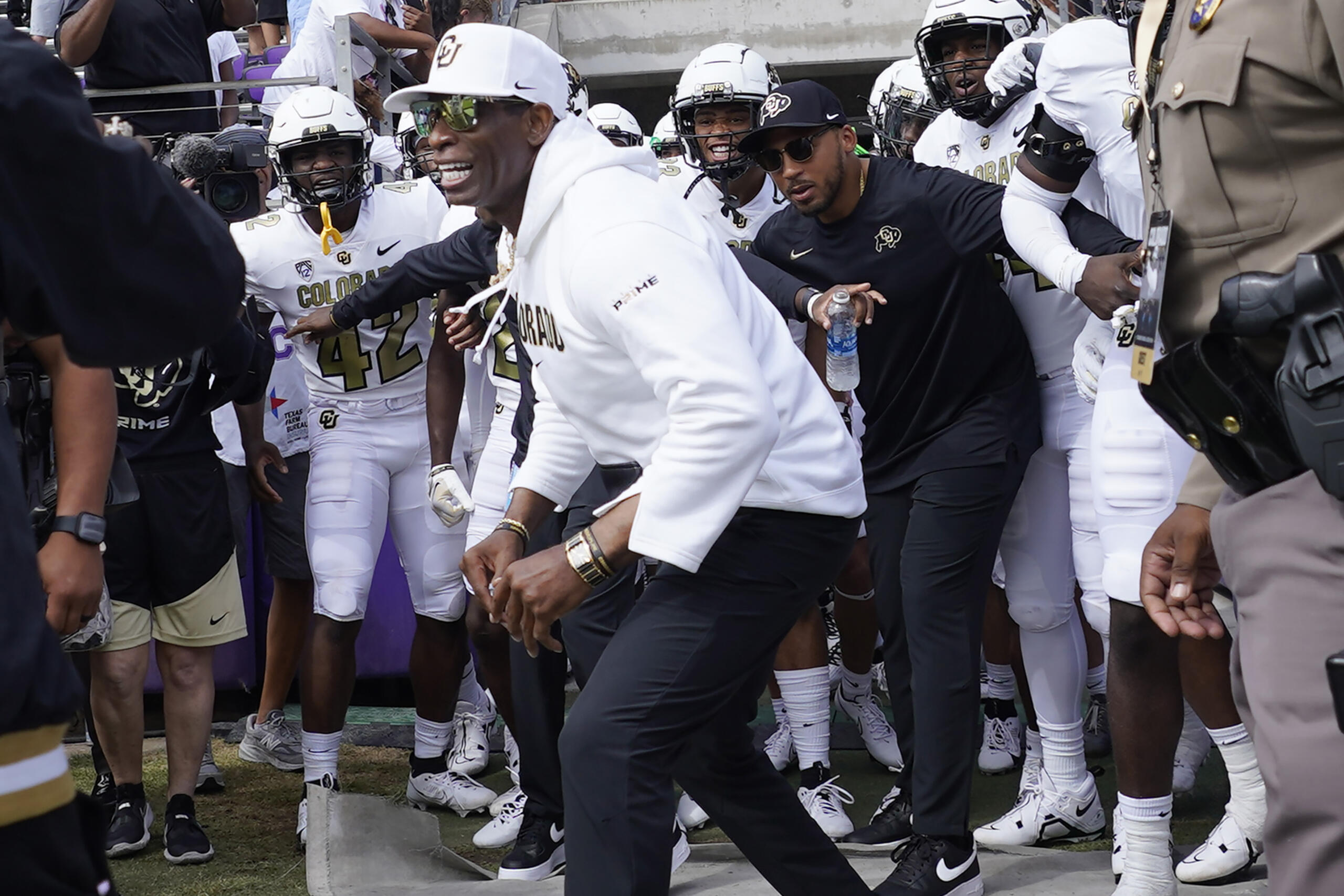 Colorado head coach Deion Sanders runs onto the field with his team for an NCAA college football game against TCU Saturday, Sept. 2, 2023, in Fort Worth, Texas.