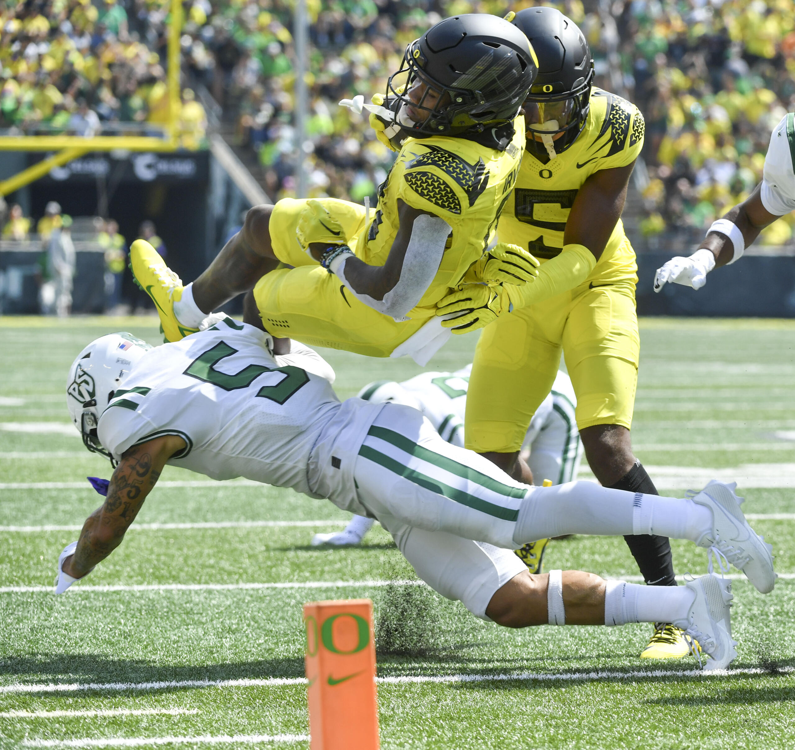 Oregon running back Bucky Irving (0) is stopped short of the goal line by Portland State defensive back Tyreese Shakir (5) as wide receiver Traeshon Holden trails on the play during the first half of an NCAA college football game Saturday, Sept. 2, 2023, in Eugene, Ore.