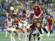 Seattle Sounders defender Jackson Ragen (25) goes up for a header on a corner kick against Portland Timbers midfielder Diego Chará, bottom center, during the second half of an MLS soccer match Saturday, Sept. 2, 2023, in Seattle. The teams played to a 2-2 draw.