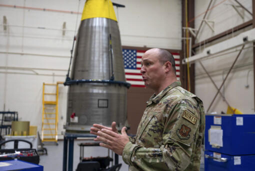 In this image provided by the U.S. Air Force, Chief Master Sgt. Andrew Zahm speaks in front of the top of a Minuteman III intercontinental ballistic missle shroud at F.E. Warren Air Force Base, Wyo., Aug. 16, 2023. Zahm has worked on the military's nuclear missile mission for 21 years. The increased workload of maintaining old missiles with fewer people has made it harder to convince younger troops to stay, especially because with their critical skillset they could make much more money in the private sector. (Senior Airman Sarah Post/U.S.