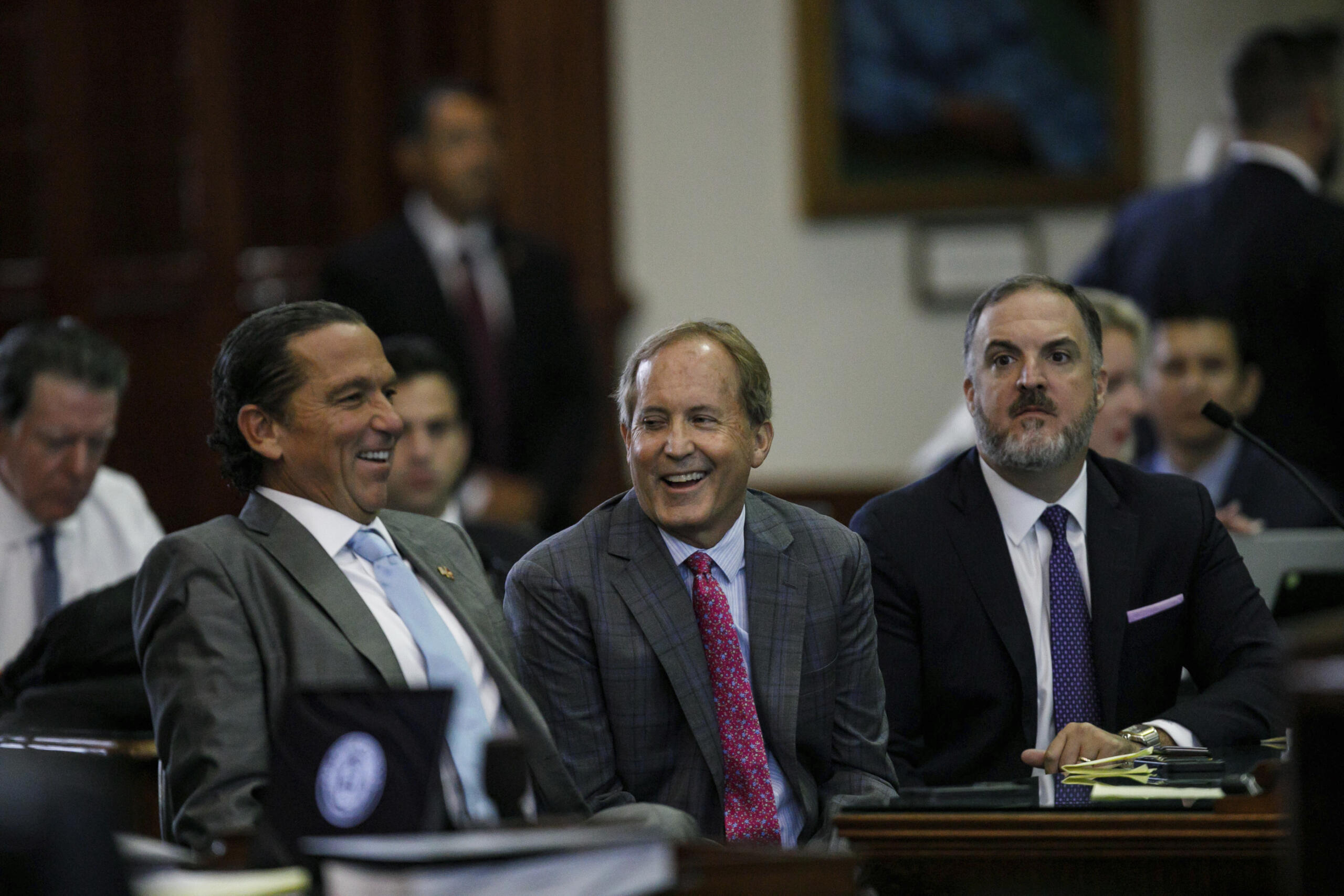 Texas Attorney General Ken Paxton, center, sits between defense attorneys Tony Buzbee, left, and Mitch Little, right, before his impeachment trial resumes in the Senate Chamber at the Texas Capitol on Friday, Sept. 15, 2023, in Austin, Texas.