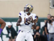Washington quarterback Michael Penix Jr. looks to throw during the first half of an NCAA college football game against Michigan State, Saturday, Sept. 16, 2023, in East Lansing, Mich.