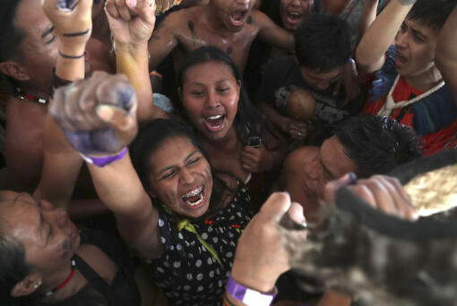 Indigenous people celebrate a Supreme Court ruling to enshrine Indigenous land rights, in Brasilia, Brazil, Thursday, Sept. 21, 2023. Six of the 11 Supreme Court justices voted against establishing a cut-off date after which Indigenous peoples could not claim new territory.