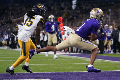Washington wide receiver Rome Odunze (1) scores a touchdown next to California defensive back Lu-Magia Hearns III (15) during the first half of an NCAA college football game Saturday, Sept. 23, 2023, in Seattle.