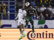 LA Galaxy defender Raheem Edwards, left, and Portland Timbers midfielder Santiago Moreno vie for the ball in the air during the second half of an MLS soccer match, Saturday, Sept. 30, 2023, in Carson, Calif.