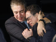A family member embraces freed American Siamak Namazi after he and four fellow detainees were released in a prisoner swap deal between U.S and Iran, arrived at Davison Army Airfield, Tuesday, Sept. 19, 2023 at Fort Belvoir, Va.