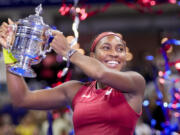 Coco Gauff, of the United States, holds up the championship trophy after defeating Aryna Sabalenka, of Belarus, in the women's singles final of the U.S. Open tennis championships, Saturday, Sept. 9, 2023, in New York.