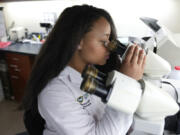 Dr. Starling Tolliver, a dermatology resident at Wayne State University, works Aug.