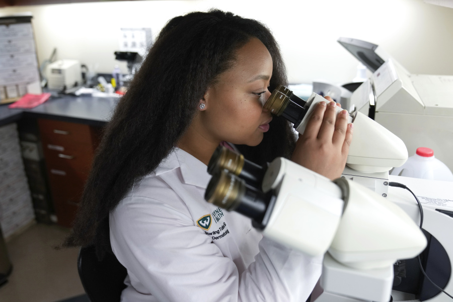 Dr. Starling Tolliver, a dermatology resident at Wayne State University, works Aug.