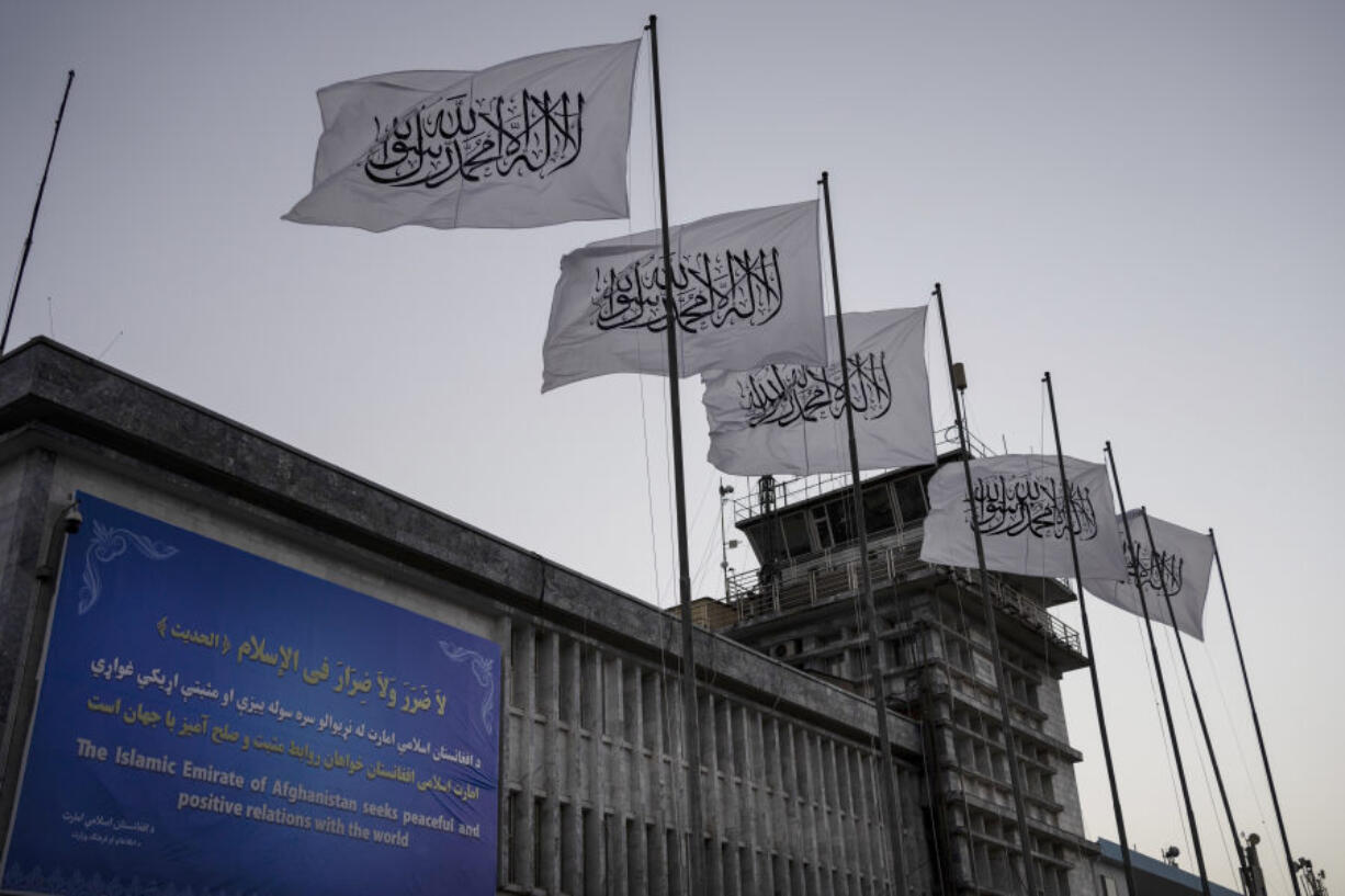FILE - Taliban flags fly at the airport in Kabul, Afghanistan, on Sept. 9, 2021. The Taliban have waged a systematic assault on the freedom of Afghanistan's people, including women and girls experiencing "immeasurably cruel" oppression, the U.N.'s human rights chief said Tuesday, Sept. 12, 2023.
