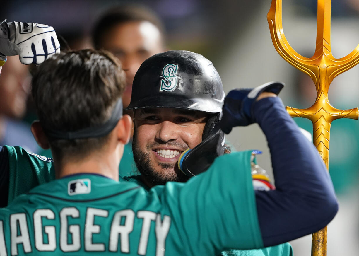 Seattle Mariners' Eugenio Suarez celebrates his solo home run against the Los Angeles Angels with Sam Haggerty during the fifth inning of a baseball game Tuesday, Sept. 12, 2023, in Seattle.