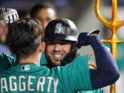 Seattle Mariners' Eugenio Suarez celebrates his solo home run against the Los Angeles Angels with Sam Haggerty during the fifth inning of a baseball game Tuesday, Sept. 12, 2023, in Seattle.