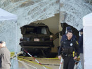 FILE - An SUV rests inside an Apple store behind a large hole in the glass front of the store, Nov. 21, 2022, in Hingham, Mass. On Tuesday, Sept. 26, 2023, a judge revoked bail for Bradley Rein, who had been confined at home while awaiting trial for driving his SUV into the Massachusetts Apple store, killing a man and injuring nearly two dozen others, officials said.