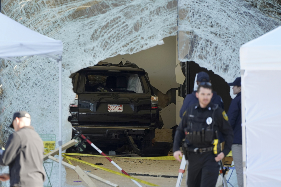 FILE - An SUV rests inside an Apple store behind a large hole in the glass front of the store, Nov. 21, 2022, in Hingham, Mass. On Tuesday, Sept. 26, 2023, a judge revoked bail for Bradley Rein, who had been confined at home while awaiting trial for driving his SUV into the Massachusetts Apple store, killing a man and injuring nearly two dozen others, officials said.