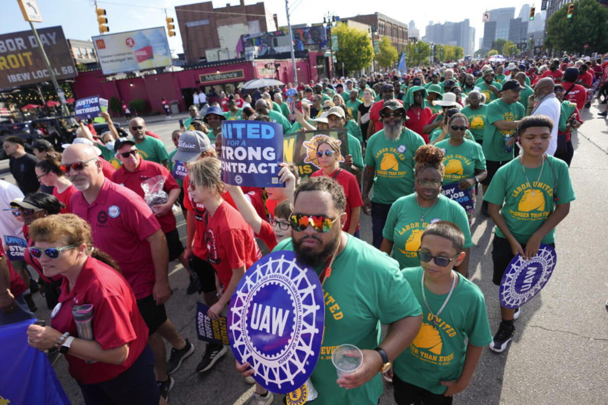 File - United Auto Workers members walk in the Labor Day parade in Detroit on Sept. 4, 2023. The union is threatening to strike any automaker that hasn't reached an agreement by the time contracts expire on Sept. 14.