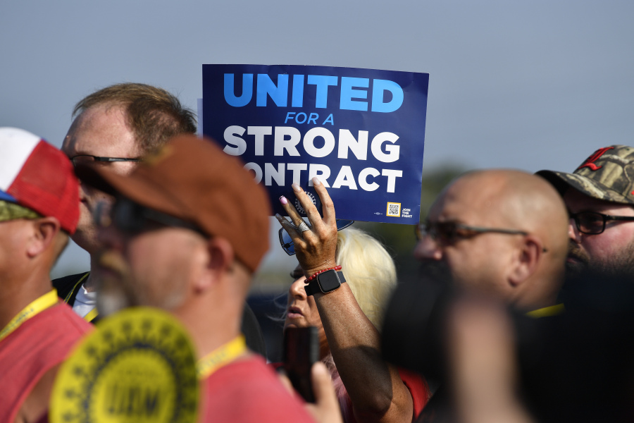 File - A member holds up a sign at a rally by United Auto Workers Local 863 in Louisville, Ky., on Aug. 24, 2023. eaders of the UAW union are considering targeted strikes at a small number of factories run by each of Detroit's three automakers if they can't reach contract agreements by a Thursday night, Sept. 12 deadline. (AP Photo/Timothy D.