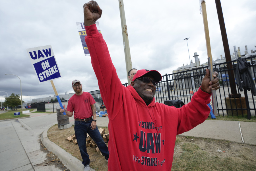 United Auto Workers member Ken Douglas pumps his fist walking the picket line at the Ford Michigan Assembly Plant in Wayne, Mich., Tuesday, Sept. 26, 2023.