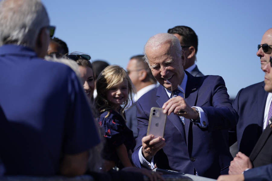 President Joe Biden takes photos with supporters on the tarmac as he arrives at Moffett Federal Field for a campaign fundraising event, Tuesday, Sept. 26, 2023, in Mountain View, Calif.