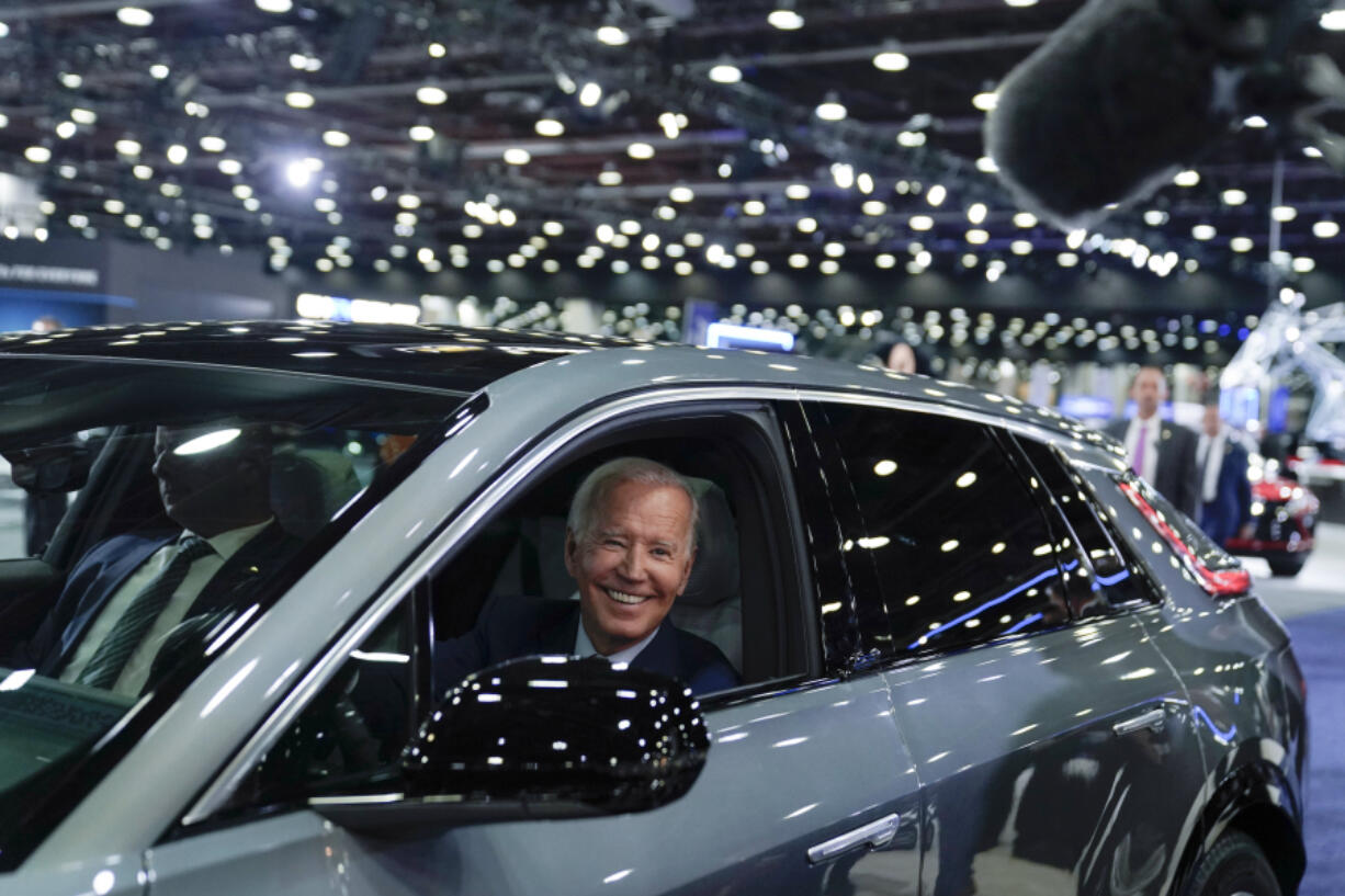 FILE - President Joe Biden drives a Cadillac Lyriq through the showroom during a tour at the Detroit Auto Show, Sept. 14, 2022, in Detroit. Efforts by the Biden administration to limit tailpipe pollution from automobiles -- a major source of planet-warming emissions -- face a crucial test as legal challenges brought by Republican-led states head to a federal appeals court.