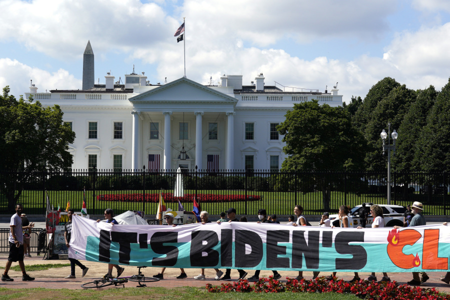 FILE - Climate activists rally in front of the White House at Lafayette Square to demand that President Joe Biden declare a climate emergency and move the country rapidly away from fossil fuels, July 4, 2023, in Washington. After being thwarted by Congress, Biden will use his executive authority to create a New Deal-style American Climate Corps that will serve as a major green jobs training program.