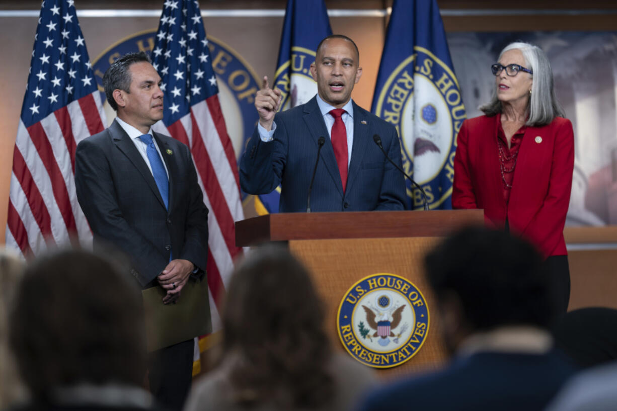 House Minority Leader Hakeem Jeffries, D-N.Y., center, is flanked by Rep. Pete Aguilar, D-Calif., the Democratic Caucus chair, left, and Rep. Katherine Clark, D-Mass., the Democratic whip, as he speaks to reporters after House Speaker Kevin McCarthy said he is launching an impeachment inquiry against President Joe Biden, at the Capitol in Washington, Tuesday, Sept. 12, 2023. (AP Photo/J.