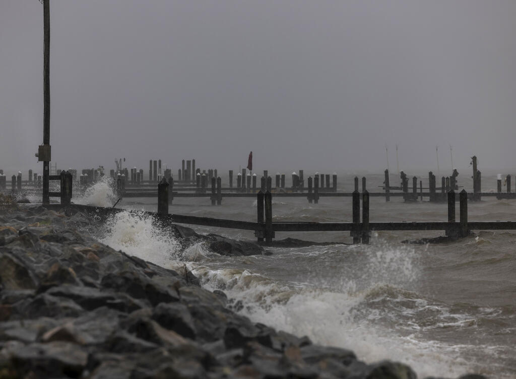 Wind driven waves slam into docks along Irving Avenue as Tropical Storm Ophelia reaches Colonial Beach, in Westmoreland County, Va., on Saturday.