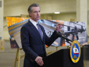 FILE - California Gov. Gavin Newsom speaks to reporters at Del Mar Fairgrounds on Feb. 18, 2022, in Del Mar, Calif. Newsom signed a law, Tuesday, Sept. 26, 2023, raising taxes on gun and ammunition sales to pay for school safety and violence prevention. (Nelvin C.