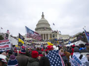 FILE - Insurrections loyal to President Donald Trump rally at the U.S. Capitol in Washington on Jan. 6, 2021. Ray Epps, an Arizona man who became the center of a conspiracy theory about Jan. 6, 2021, has been charged with a misdemeanor offense in connection with the U.S. Capitol riot, according to court papers filed Tuesday.  Epps is charged with a single count of a disorderly or disruptive conduct on restricted grounds.