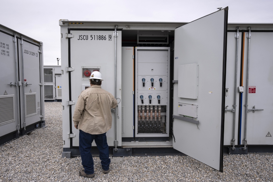 FILE - An employee works at a battery energy storage facility in Saginaw, Texas, April 25, 2023, that is owned and operated by Eolian L.P. The U.S. Department of Energy on Friday, Sept. 22, announced a $325 million investment in long-duration battery storage projects.