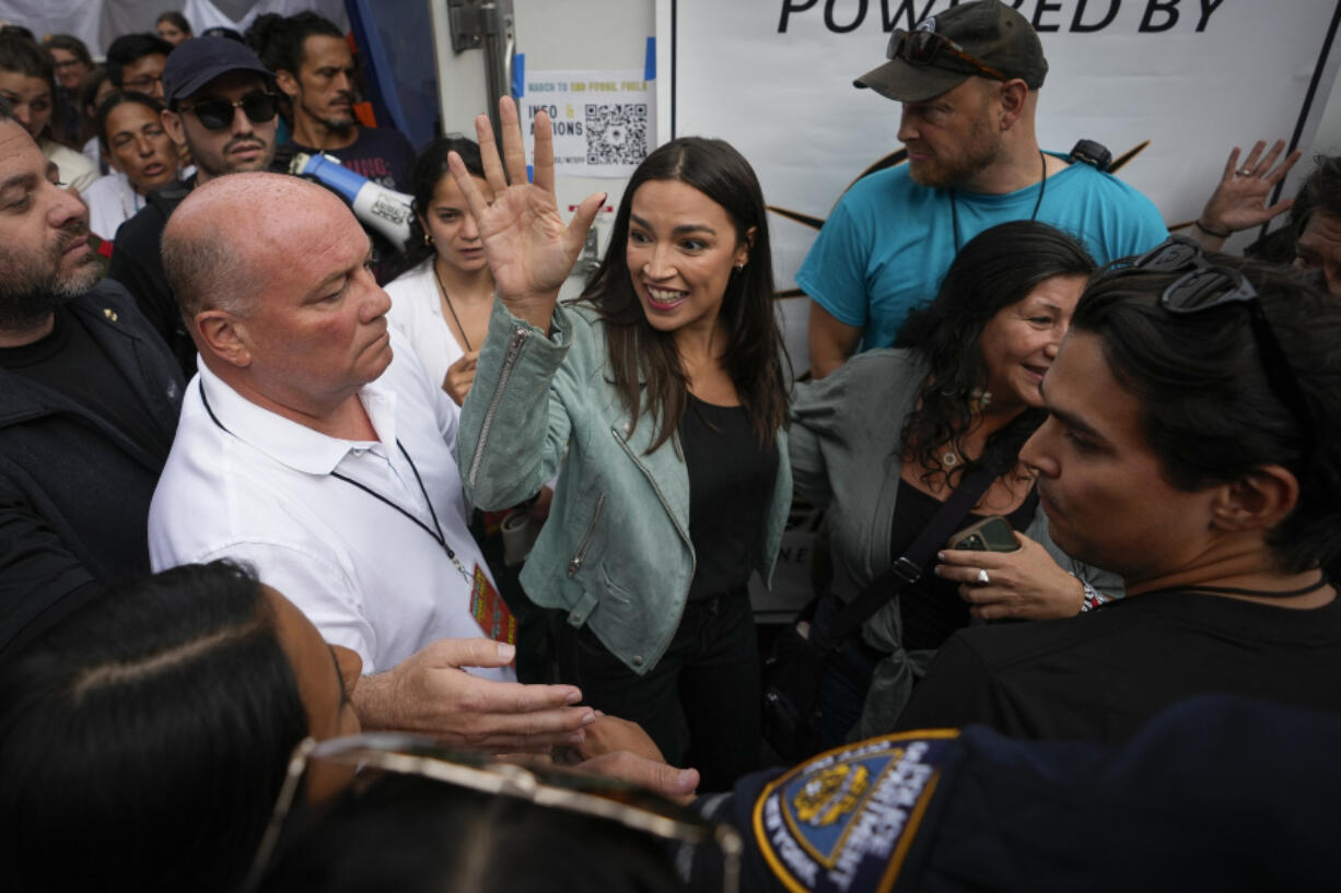 U.S. Rep. Alexandria Ocasio-Cortez (D-N.Y) waves to supporters after speaking at a rally to end the use of fossil fuels, in New York, Sunday, Sept. 17, 2023.